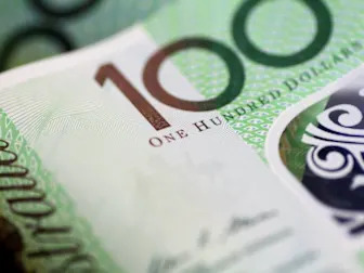 Australia dollar slips as RBA cuts rates, warns on global outlook