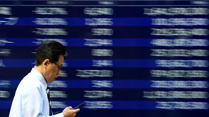 Stocks, dollar slide as Trump’s attacks on Fed shake markets